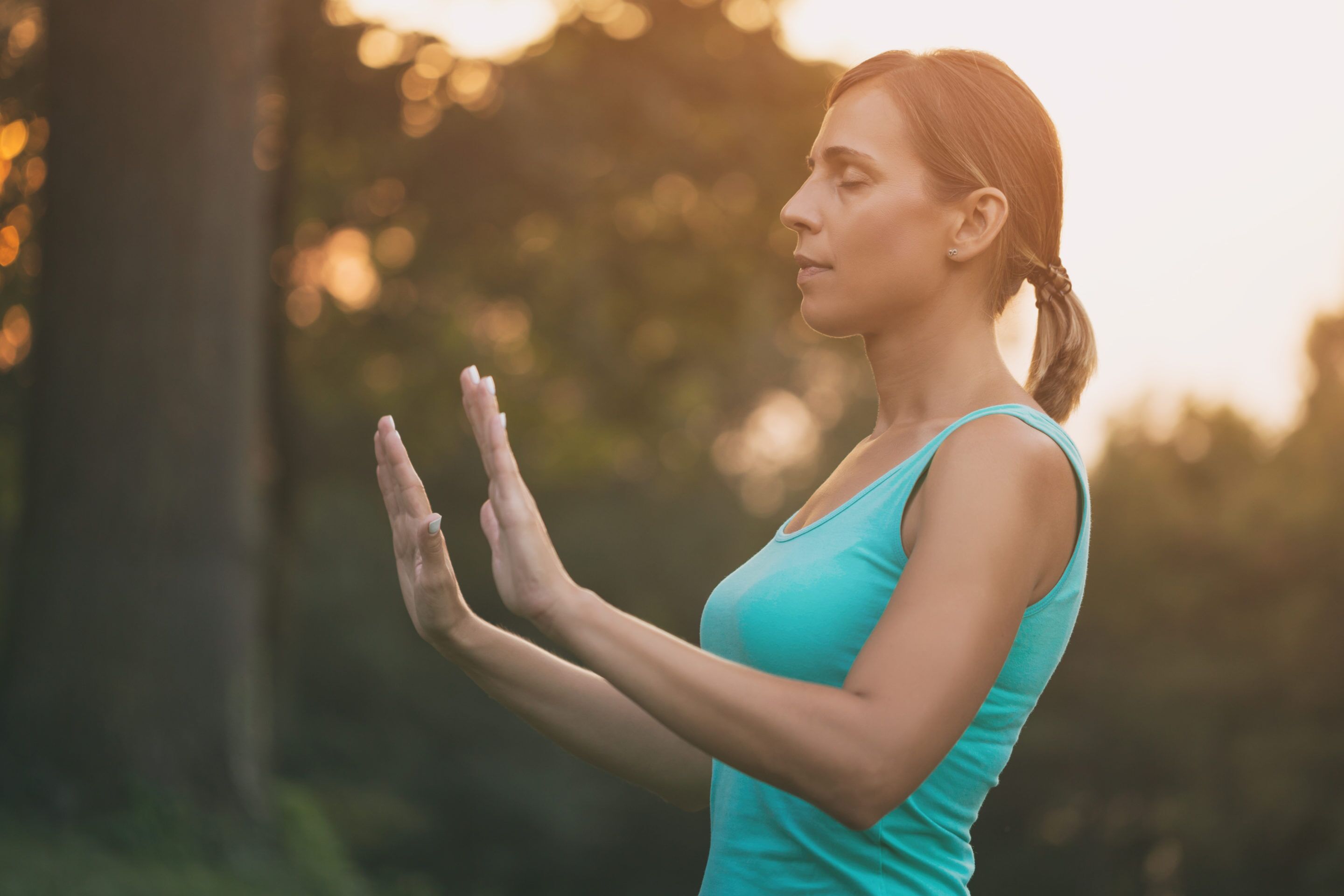 Woman practicing qigong outside