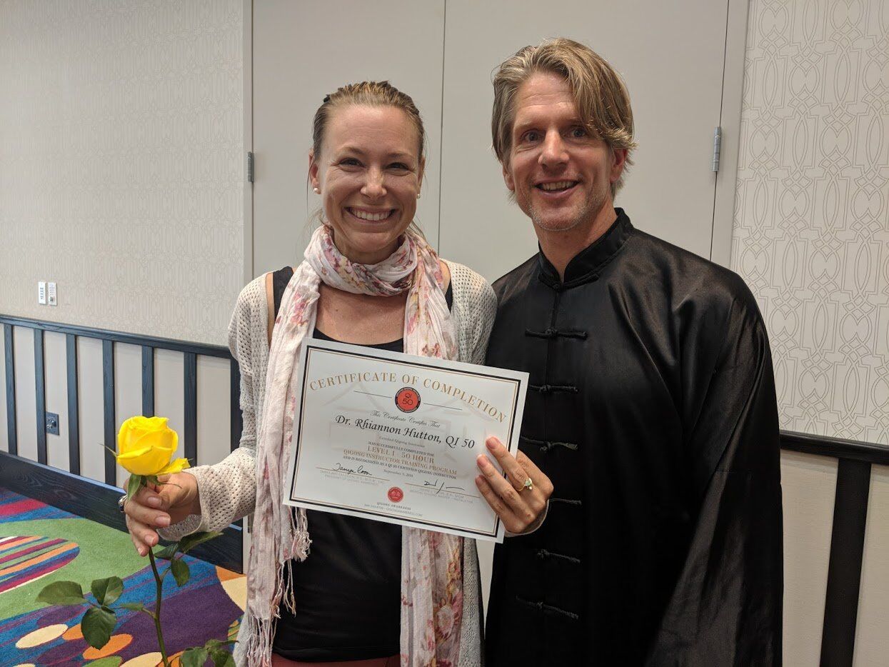 Student Dr. Rhiannon Hutton receives level I Qigong Awareness Certified Qigong Instructor Certificate at closing of Live Workshop
