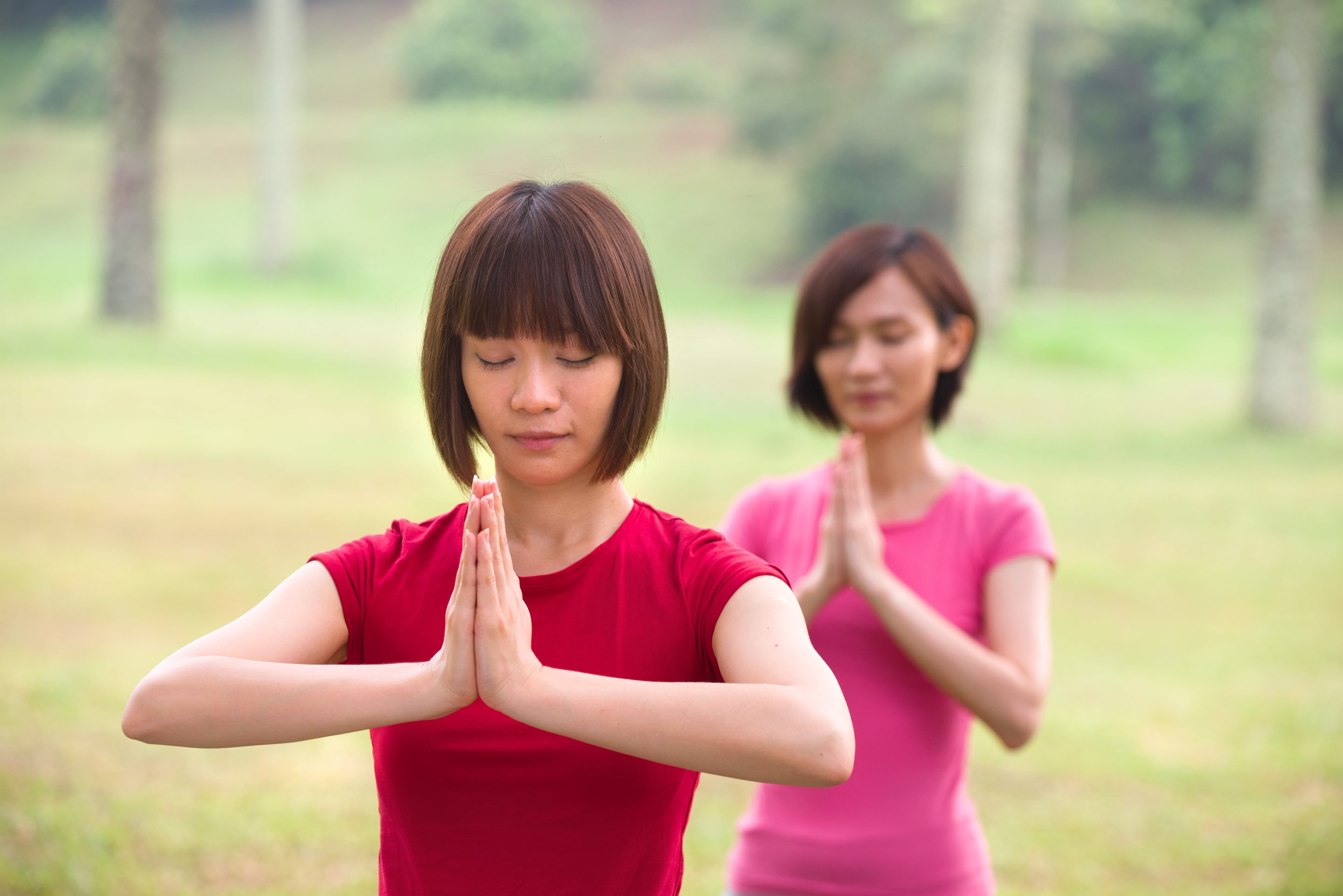 Women meditating outside